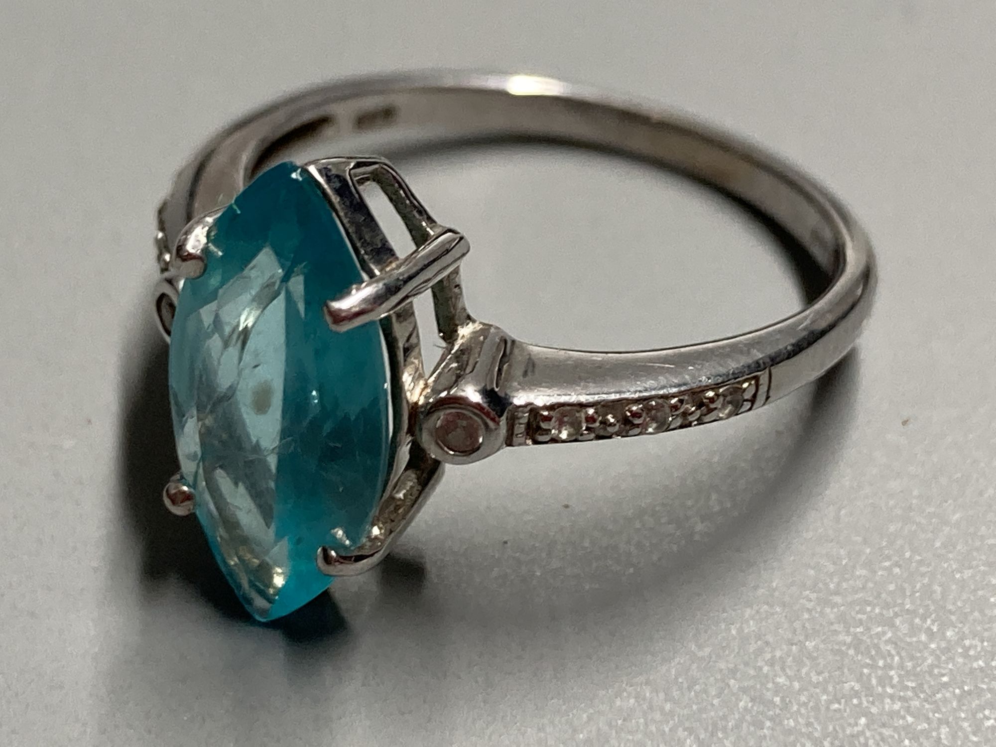 Three assorted modern 9ct and gem set dress rings, including white gold and marquise shaped blue topaz ring, size N/O,